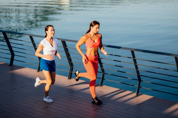 istock Women jogging next to a river 1205233845
