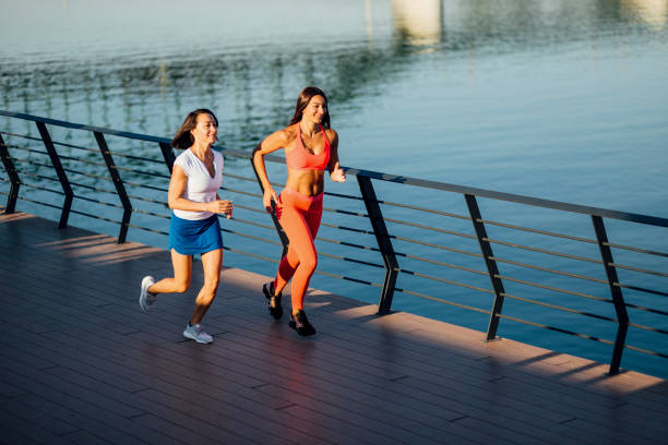 istock Women jogging next to a river 1205233874