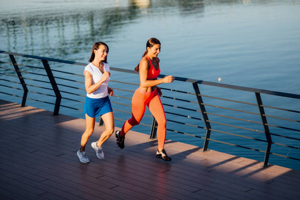 Women jogging next to a river