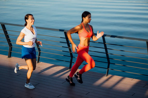 istock Women jogging next to a river 1205233928