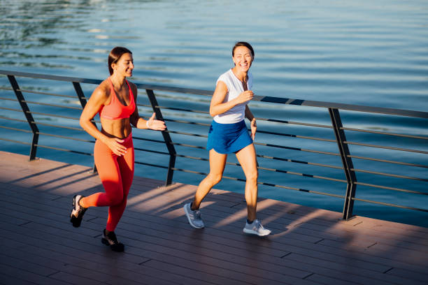istock Women jogging next to a river 1205233940