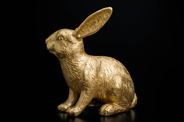 istock gold bunny rabbit in pink  background with gold egg 1205234013