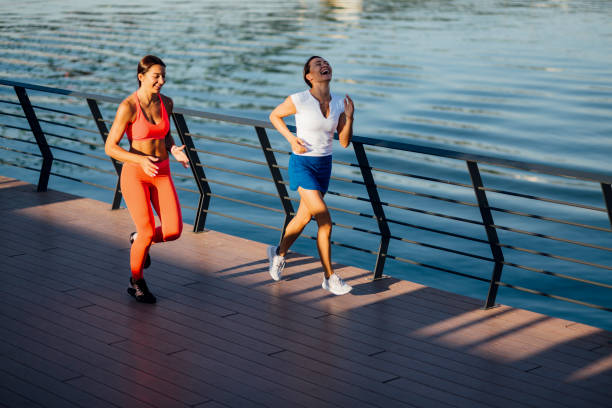 istock Women jogging next to a river 1205234415
