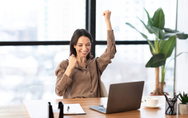 istock Ecstatic girl found new good idea raising clenched fists 1205235131