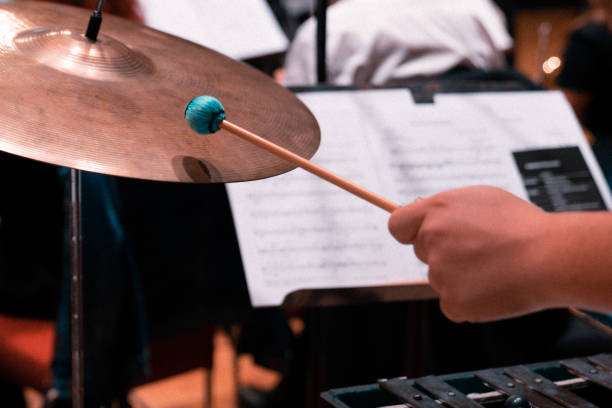 istock Close up of cymbal and man hand holding drumstick 1205235521