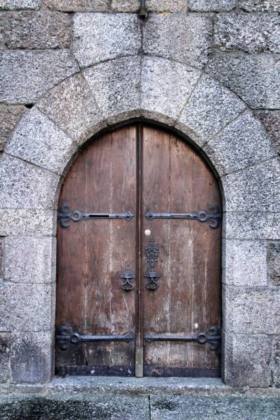 istock Old wooden brown door with wrought iron details 1205236113