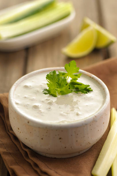 Blue cheese sauce in a portion with fresh vegetables and lime and green parsley. stock photo