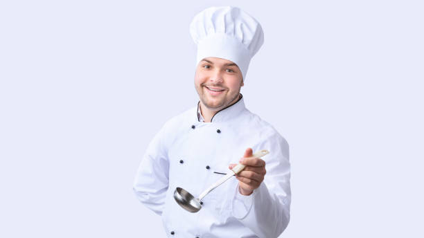 istock Happy Cook Posing With Ladle Soup Spoon, Studio Shot, Panorama 1205237235