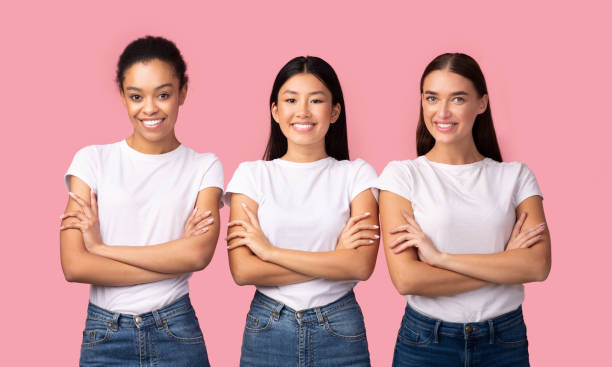istock Three Multiethnic Women Posing Crossing Hands Over Pink Background, Studio 1205237266
