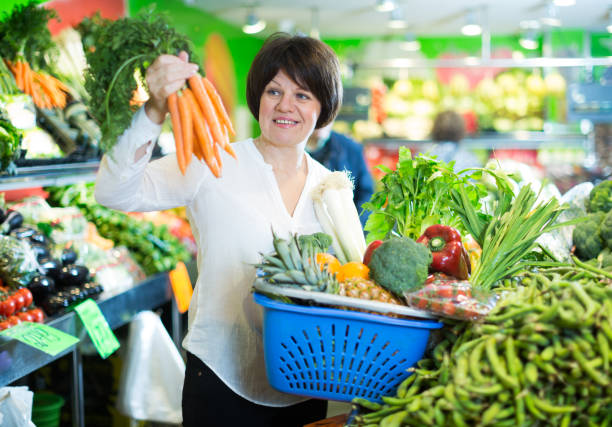 istock Mature woman buying fresh vegetables 1205237372