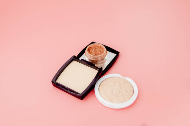 tonal foundation and highlighter, base for make-up in the form of a cushion. highlighter powder cosmetic product top view - powder puff imagens e fotografias de stock