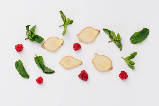 Flat lay of mint leaves, raspberries and ginger root slices. Top view