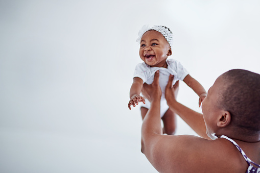 Shot of an adorable baby girl bonding with her mother at home