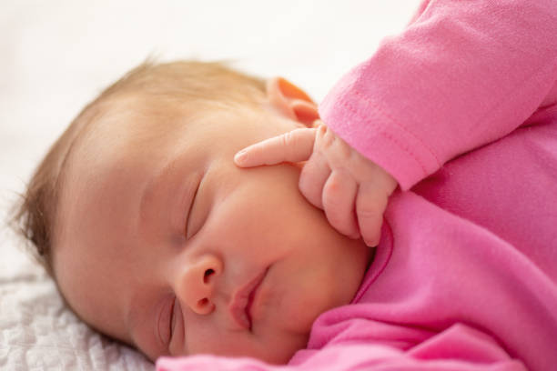 istock Cute little newborn sleeping with his finger on face 1205239251
