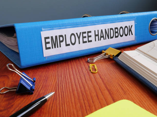 istock Text sign showing the printed words Employee Handbook 1205239862