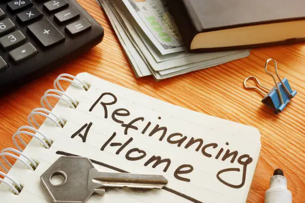 Photo of Conceptual photo is showing printed text refinancing a home