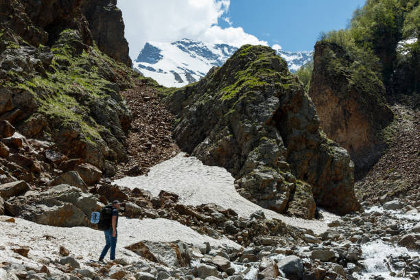 istock A backpacker climbs to the top of a snow-covered mountain 1205241130