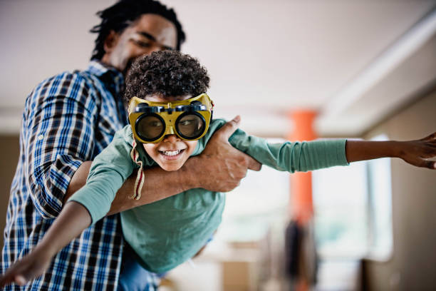 istock Happy black boy having fun with his father at home. 1205241358