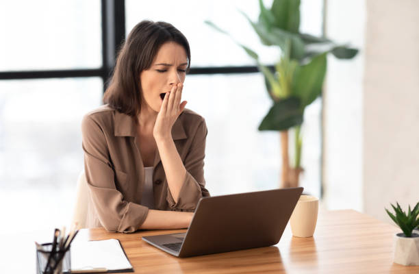 istock European young manager yawning at work place 1205241511