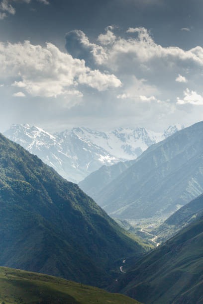 istock Snow-capped mountain peaks on a cloudy summer day. 1205241535