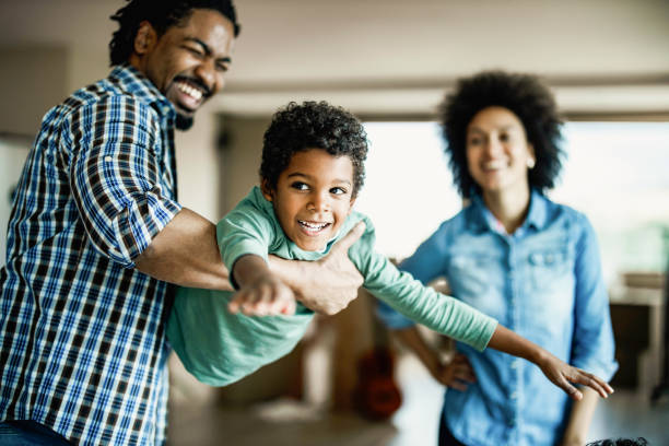 istock Happy African American boy having fun with his father at home. 1205241971