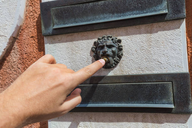 istock Hand and retro doorbell 1205243496