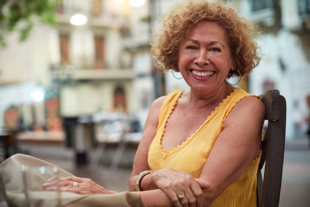 istock Senior woman looking at camera and sitting down in a cafe. 1205244534
