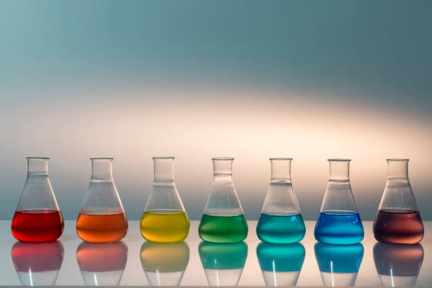istock Scientific laboratory glass erlenmeyer flask filled with colorful liquid forming rainbow. 1205245214