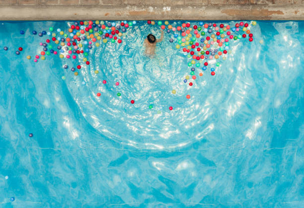 Boys playing with balls at the pool in Mexico