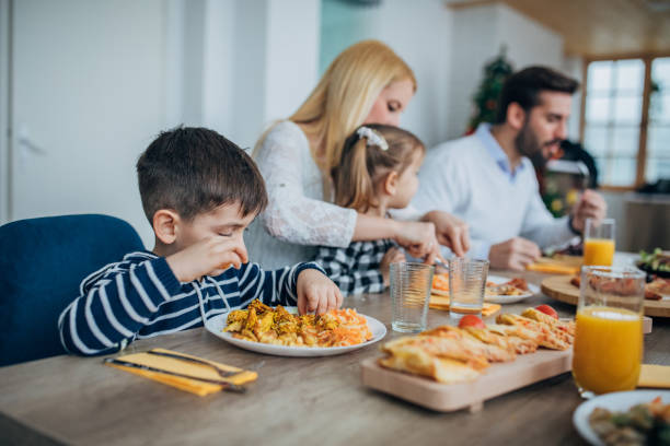istock Young married couple having lunch with their two children 1205246823