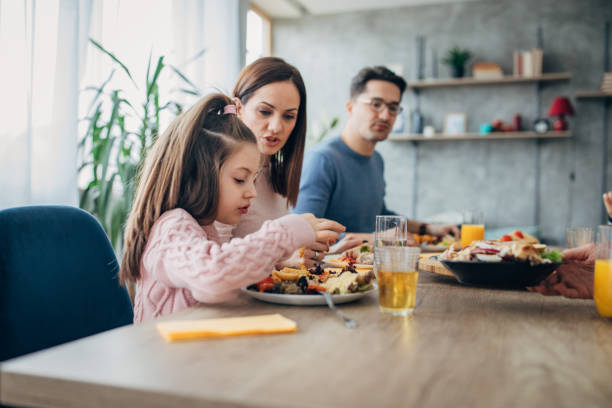 istock Young married couple having lunch with their daughter 1205246909