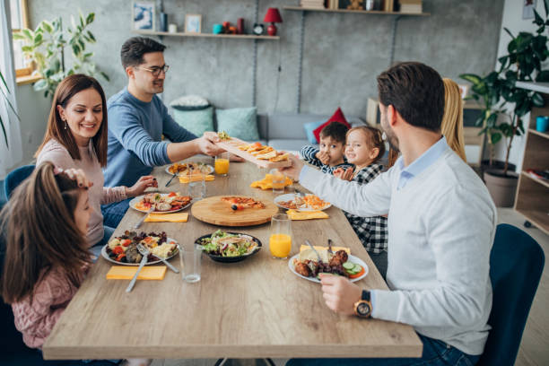 istock Married couples and friends with children having lunch together 1205247185