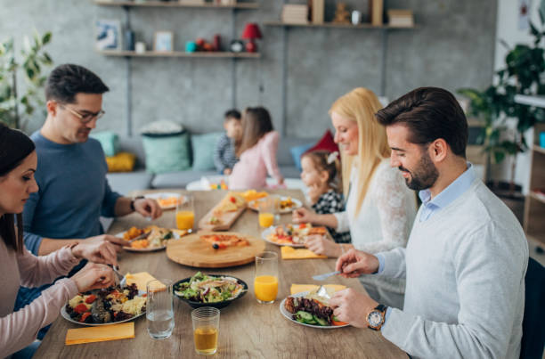 istock Happy married couples and friends with children having lunch together 1205247263