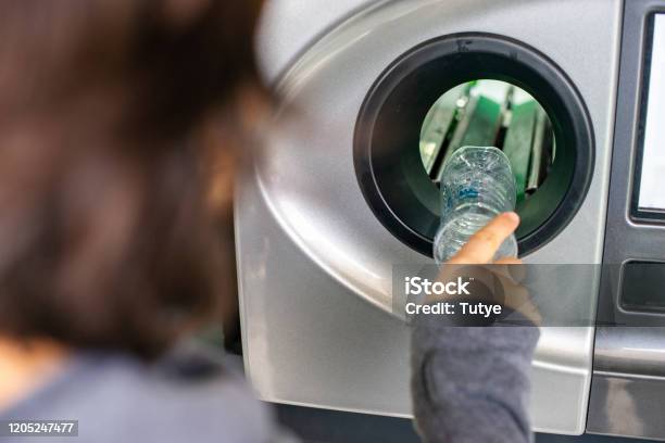 Woman At The Reverse Vending Machine Recycle Plastic Bottles Ecology Concept Stock Photo - Download Image Now