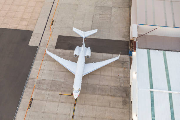 istock White unbranded private jet Plane waiting in runway 1205248060