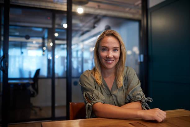 istock Business office worker sitting in the board room and looking at camera. 1205248087