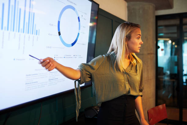istock One young businesswoman making a presentation speech. 1205248106
