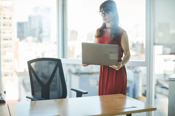 istock Arriving at the desk with a laptop and ready to work. 1205248116
