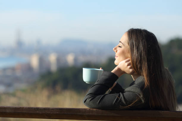 istock Businesswoman relaxing drinking coffee sitting on a bench 1205251871
