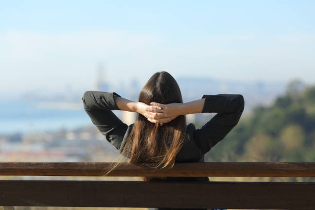 istock Businesswoman relaxing resting sitting on a bench 1205252255