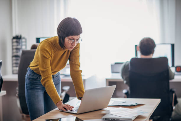 istock Pretty young woman in the office working 1205252294