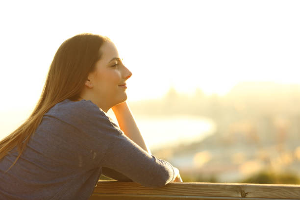 istock Satisfied woman contemplating views at sunset 1205252465
