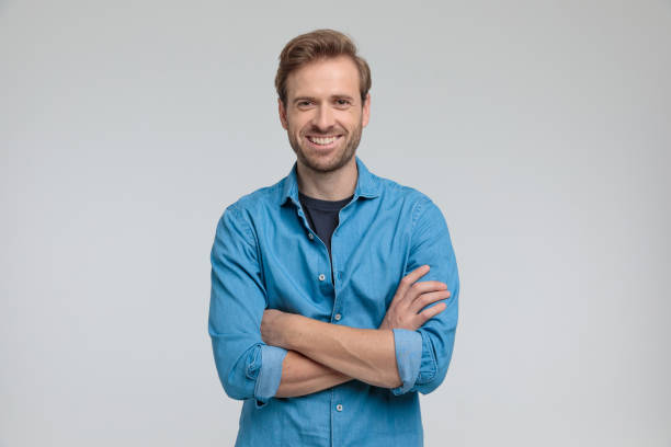 istock enthusiastic young casual man crossing arms and smiling 1205252676