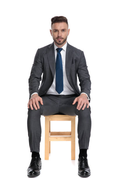 istock serious young businessman holding hands on knees 1205254094