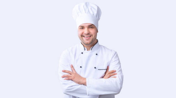 istock Smiling Chef Man Standing Crossing Hands In Studio, Panorama 1205256312