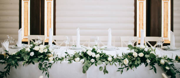 istock Beautiful table decoration with green leaves and gold candlesticks 1205257149