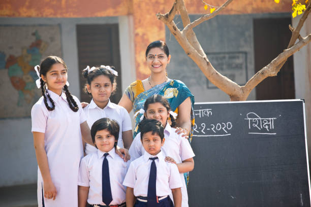 istock Teacher and kids at school campus 1205257210