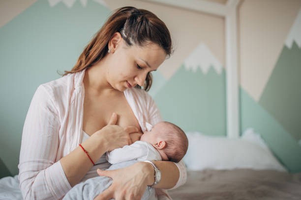 istock Mother breastfeeding her baby boy at home 1205257310