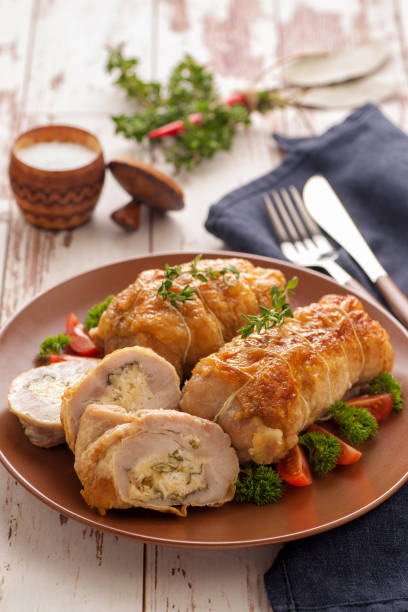 istock Stuffed chicken roll s vegetable garnish and herbs. 1205257797