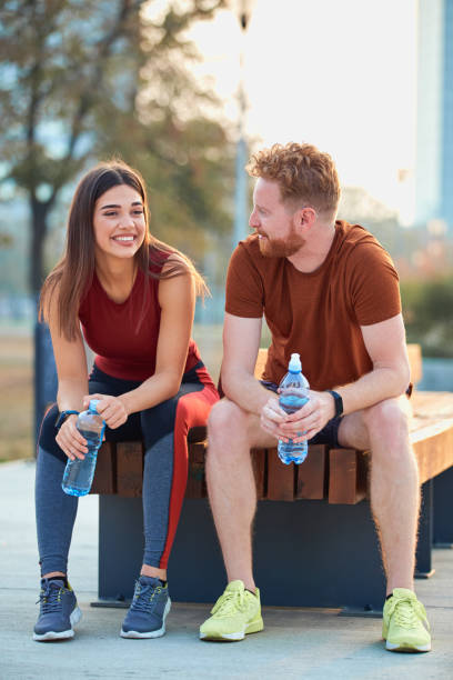 istock Modern couple making pause in an urban park during jogging / exercise. 1205259842